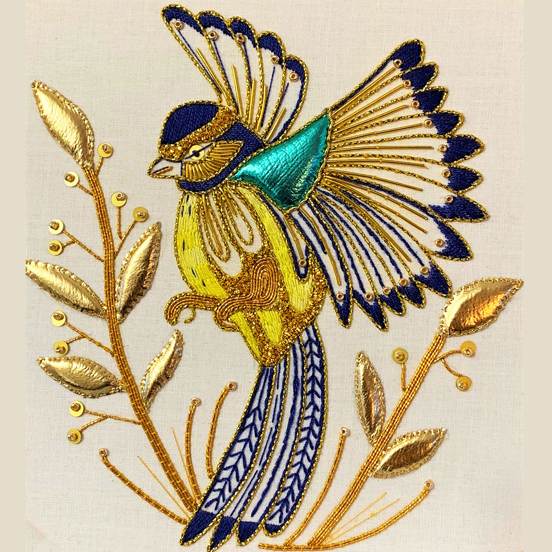 Goldwork embroidery of a Blue Tit in flight